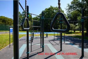 a playground with two swings in a park at location Vakañsoù in Lanouée