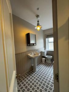 a bathroom with a sink and a toilet at NEW - Large Portrush Townhouse in Portrush
