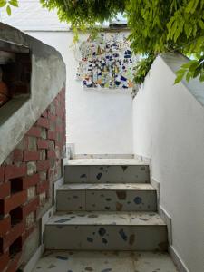 a set of stairs next to a brick wall at Mansarda in Veli Lošinj +4 photos