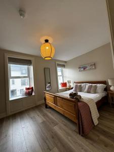 a bedroom with a large bed and a light at NEW - Large Portrush Townhouse in Portrush +19 photos