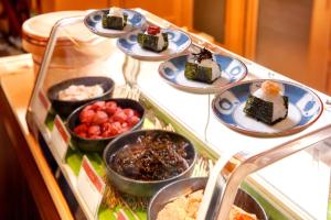 a display case filled with different types of desserts at Sheraton Miyako Hotel Osaka in Osaka