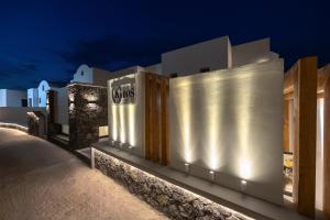 a building with lights on it at night at Kudos Suites Firostefani in Fira