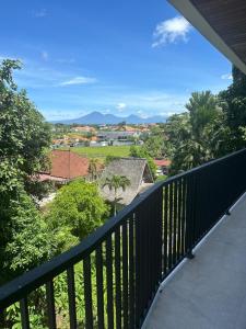 a balcony with a view of a city at Onyx Beach Hotel in Canggu
