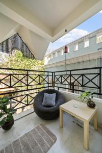 a large balcony with a chair and a table at Artist Abode in Bangalore