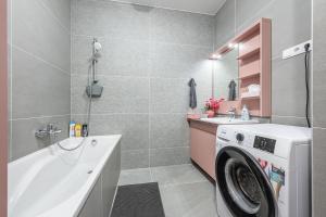 a bathroom with a washing machine and a sink at Condos with Garage and Balcony in City Center in Budapest