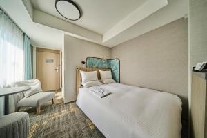 Postel nebo postele na pokoji v ubytování Hotel Flora Funabashi