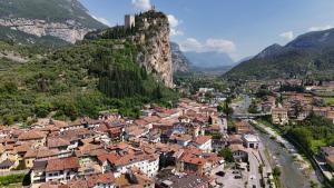 a town with a castle on the side of a mountain at Appartamento al Gallo con terrazzo in Arco