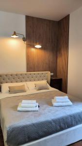 a bedroom with a bed with two towels on it at Villa Marchesa in Arona