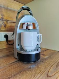 a coffee maker is sitting on a wooden floor at Appartements Kolberhof in Alpbach