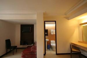 a living room with a couch and a bathroom at Olongapo Travel Lodge in Olongapo