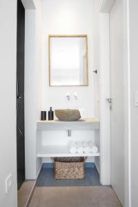 a bathroom with a sink and a mirror at Villa Gianna Maria in Paleros +22 photos