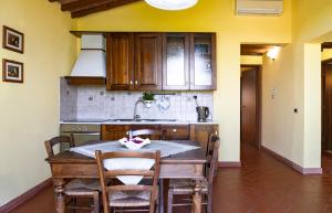 a kitchen with a table and chairs in a room at Country House Oasi Verde Near Florence in Cerreto Guidi