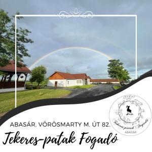 a rainbow in the sky over a house at Tekeres-patak Fogadó in Pálosvörösmart