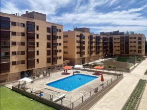 an overhead view of a swimming pool in front of buildings at campezo in Madrid