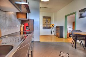 a kitchen with a sink and a table in a room at Schwalbennest in Naumburg