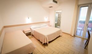 a white bedroom with a bed and a window at Agriturismo Marina in Ortona +57 photos