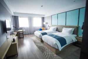 Ένα ή περισσότερα κρεβάτια σε δωμάτιο στο Echarm Hotel - Jingmen Yintai City Jingchu Institute of Technology