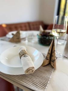 a table with a plate and a glass of wine at Meldaria Residence in Krk +18 photos