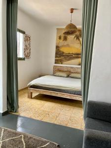 a bedroom with a bed and a painting on the wall at Studio Aqua in La Oliva