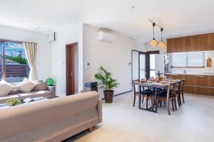 a living room with a couch and a table at Kerama the day in Awaren