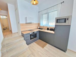 a kitchen with a sink and a microwave at Cabacum Paradise 1 on the seashore in Varna City