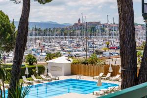 a pool with a view of a marina at Hôtel Ibaïa - Piscine & Spa in Hendaye