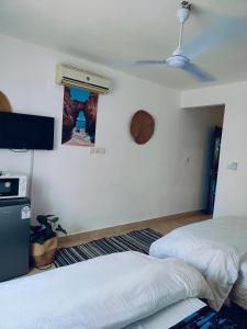 a bedroom with two beds and a wall with a window at Beach Front Luxury 2 Bedroom Mombasa in Mombasa