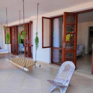 a swing in a living room with a chair at Beach Front Luxury 2 Bedroom Mombasa in Mombasa