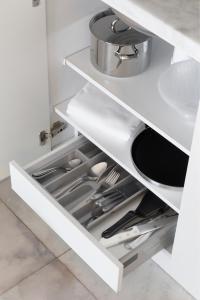 a kitchen with white cabinets and a sink at Crowne Plaza - Caparica Lisbon in Costa da Caparica