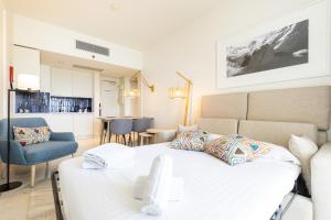 a bedroom with a bed and a living room at Crowne Plaza - Caparica Lisbon in Costa da Caparica