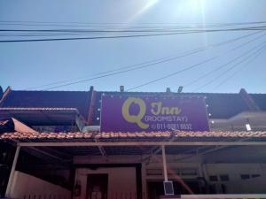 a building with a sign on the top of it at Q INN HOTEL Kerteh in Kampong Pengkalan Pangan