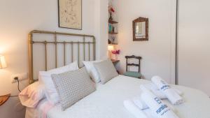 a bedroom with a white bed with white pillows at Casa Arcos de Almona Frigiliana by Ruralidays in Frigiliana +26 photos