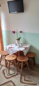 a table and four chairs with a vase with flowers on it at U KOMINKA in Zakopane