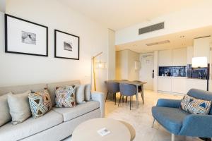 a living room with a couch and a table at Crowne Plaza - Caparica Lisbon in Costa da Caparica