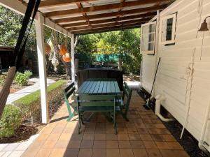 a picnic table under a pergola on a patio at Swallows Cottage, Margaret River in Witchcliffe