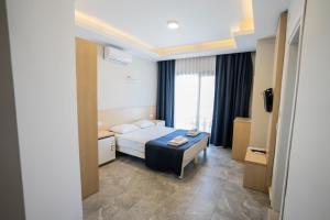 Postel nebo postele na pokoji v ubytování M2 Hotel