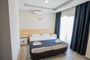 Postel nebo postele na pokoji v ubytování M2 Hotel
