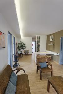 a living room with a couch and chairs and a table at Emerald Avenue Cozy 3R3B Apartment 830 in Brinchang