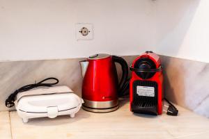 a coffee maker and a toaster sitting on a counter at Milea Traditional House-Private Garden Retreat in Miléa