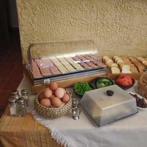 a table with eggs and other food items on it at Maistrali Hotel & Restaurant in Kalavárda