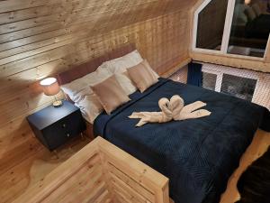 a bedroom with a bed with a towel on it at Korbielów 6 in Korbielów