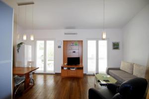 a living room with a couch and a table at Holiday house Goja in Medulin