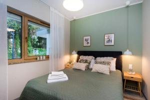 Posteľ alebo postele v izbe v ubytovaní Bursztynowe Tarasy - Apartamenty