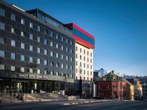 a large building with a sign on the side of it at Quality Hotel Grand Royal in Narvik