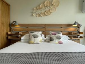 a bedroom with a bed with two pillows on it at Beach Lodge in Bournemouth