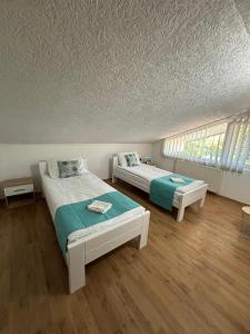 a bedroom with two beds and a ceiling at Riverside Resort Una in Bihać