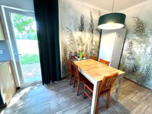 a dining room with a wooden table and chairs at Leśny Dworek in Żary +22 photos