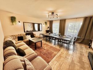 a living room with a couch and a table at Leśny Dworek in Żary