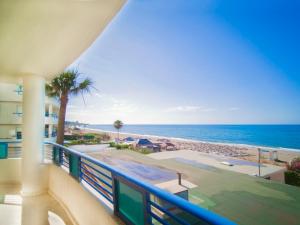 a balcony with a view of the beach at Banana Beach in Marbella