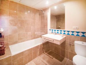 a bathroom with a sink and a tub and a toilet at Banana Beach in Marbella